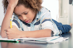 Boy struggling with homework.