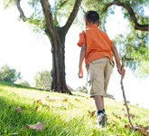 boy walking on grass